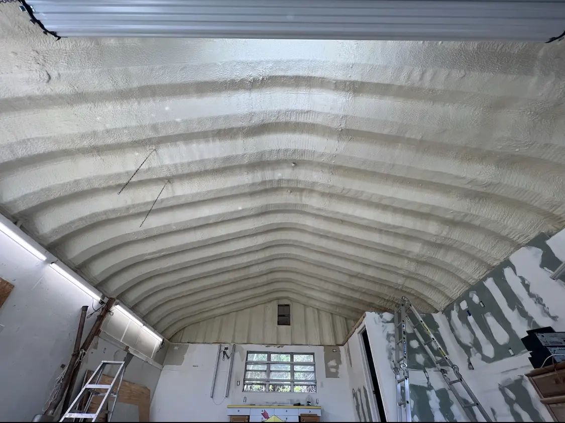 Spray polyurethane foam applied to the underside of a metal roof deck in Providence